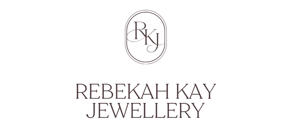 A minimalist brand logo for Rebekah Kay Jewellery, featuring an oval monogram with the initials 'RKJ' above the full brand name in a serif typeface, all centered on a solid white background.